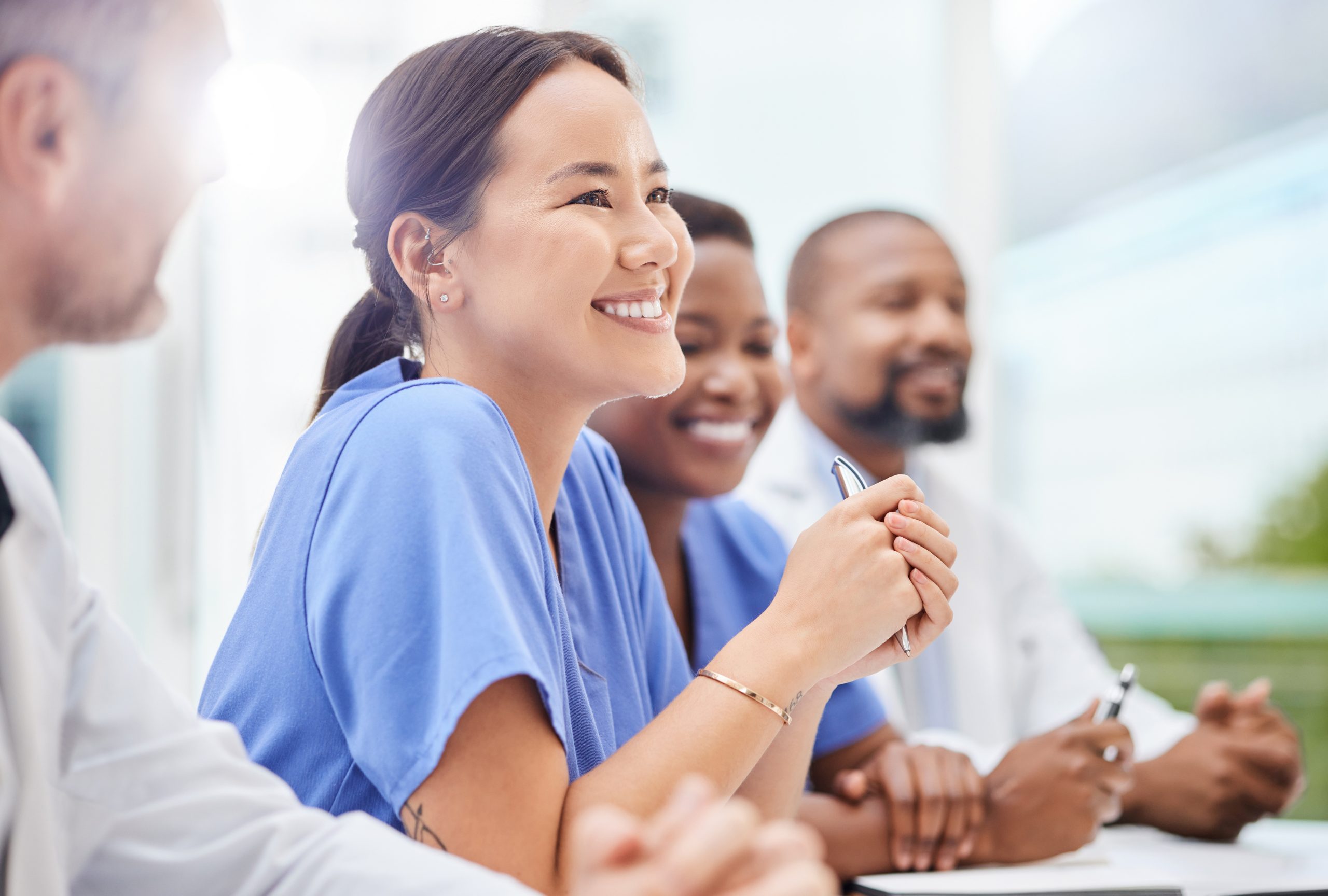 shot-of-a-doctor-sitting-alongside-his-colleagues-during-a-meeting-in-a-hospital-boardroom