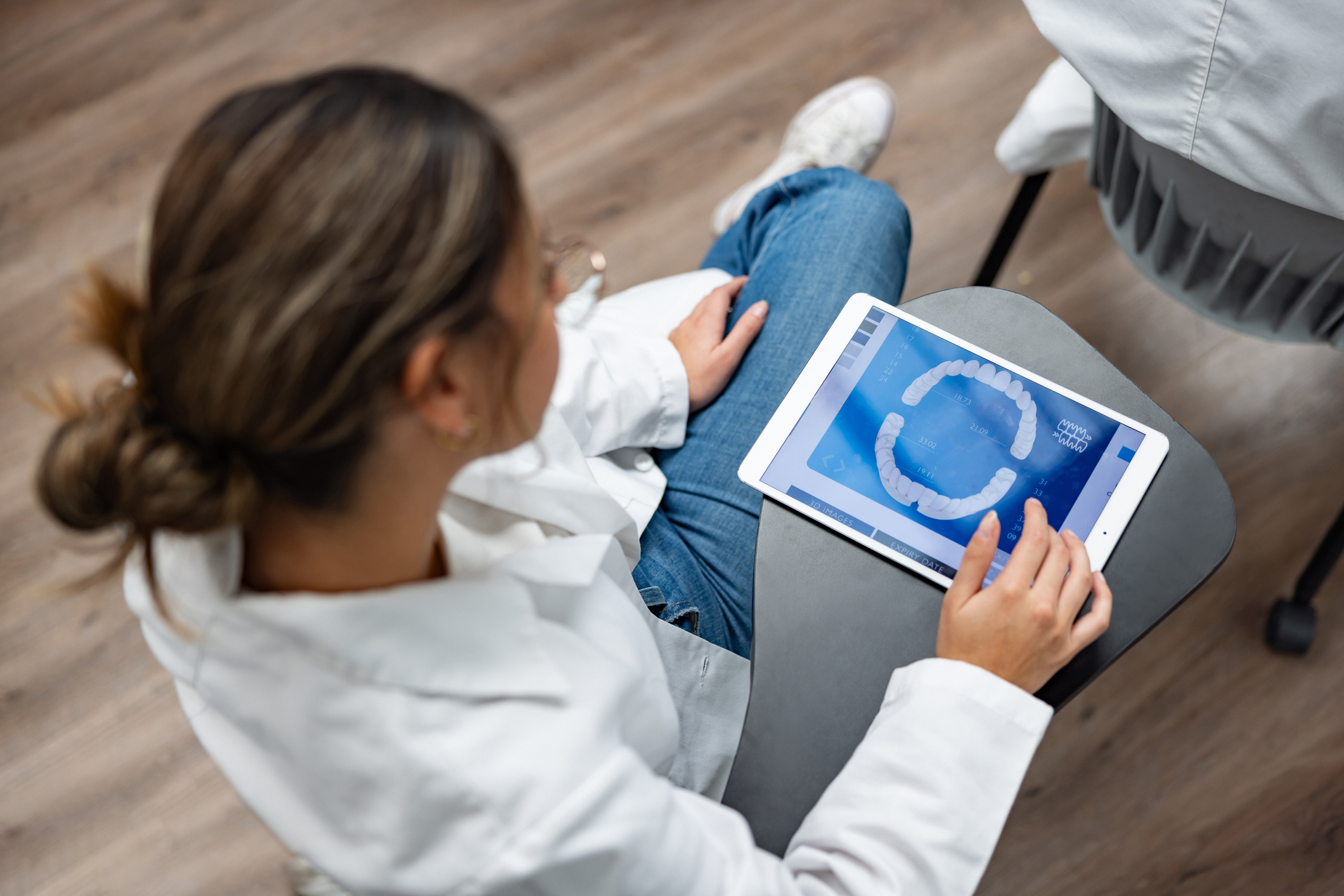 Dentist using a digital tablet and taking notes